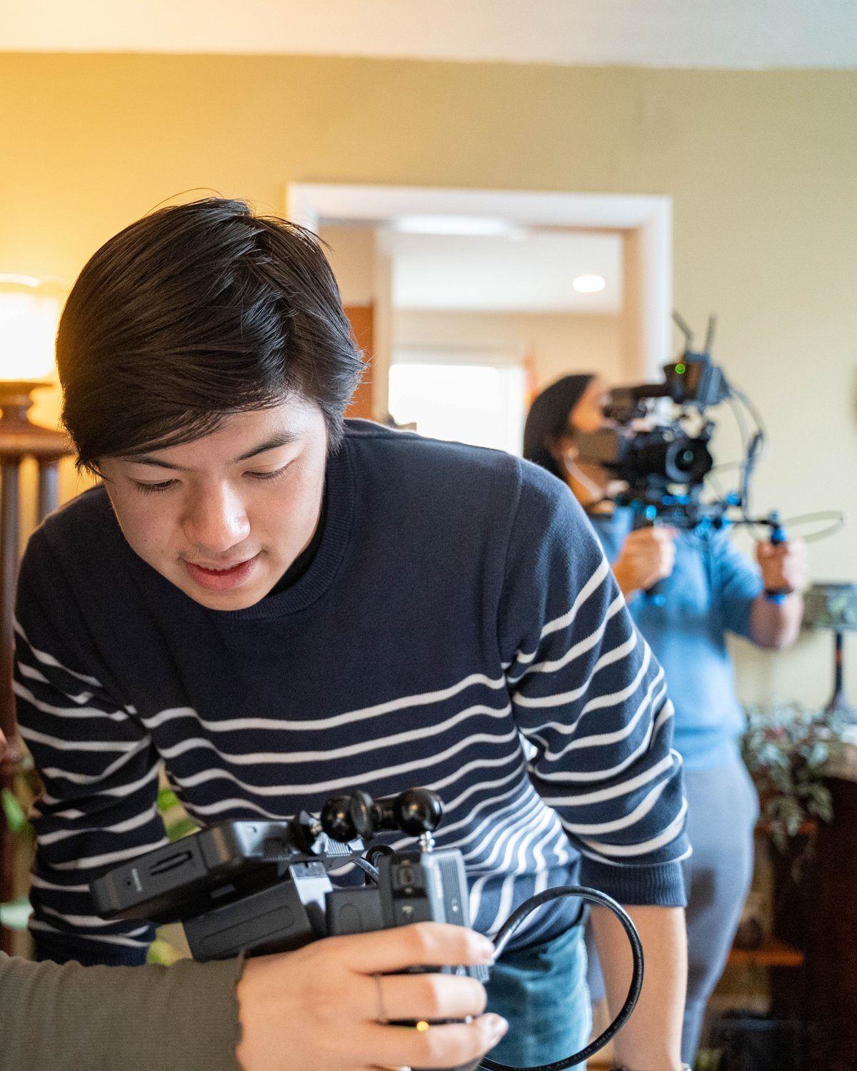Javin Lu, founder of Prima Persona, behind the camera on a shoot
